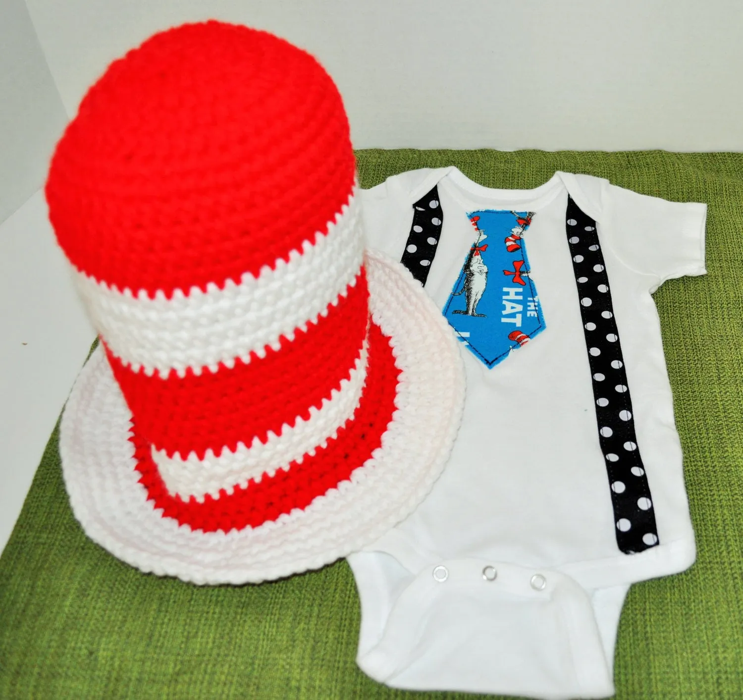 Dr. Seuss cake smash tie and black with white polka dot suspenders and red and white crochet Dr Seuss hat . birthday, cake smash